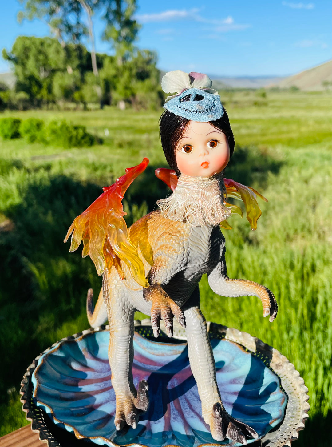 Vintage toy dinosaur with Madame Alexander doll head, "flapper style" hat and flame wings. 9" tall x 9" long x 5" wide