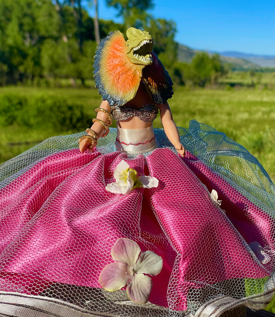 Vintage doll in belly dance outfit and flared dinosaur head. Pink satin dress adorned with tulle and flowers, snake arm bracelet . 6" tall x 2 "wide