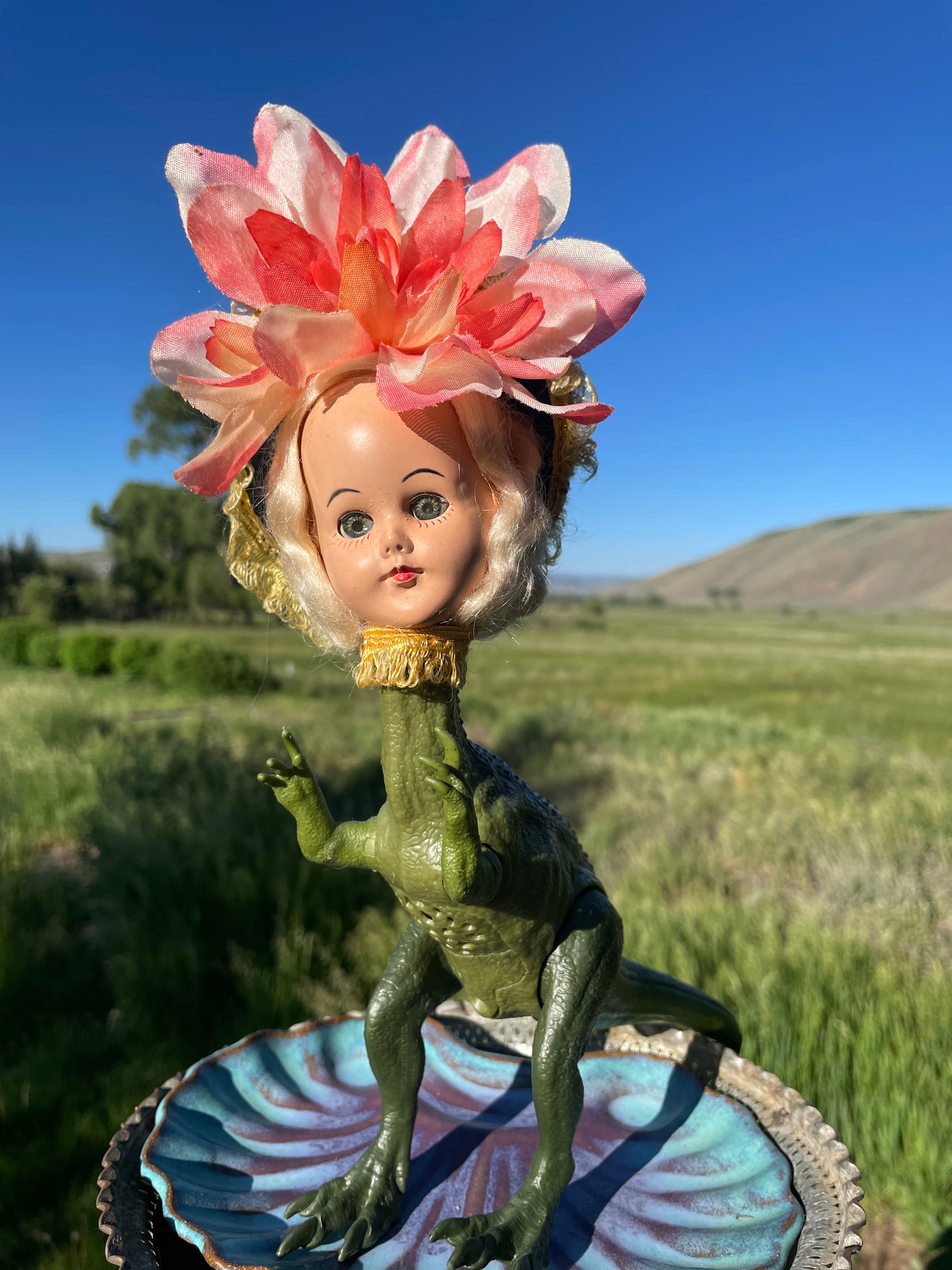 stic jointed dinosaur body with pose able arms and legs, vintage doll head and flower headdress. Has a working voice box with dinosaur growls - see video below. New batteries. 11" tall x 3" wide x 9" long