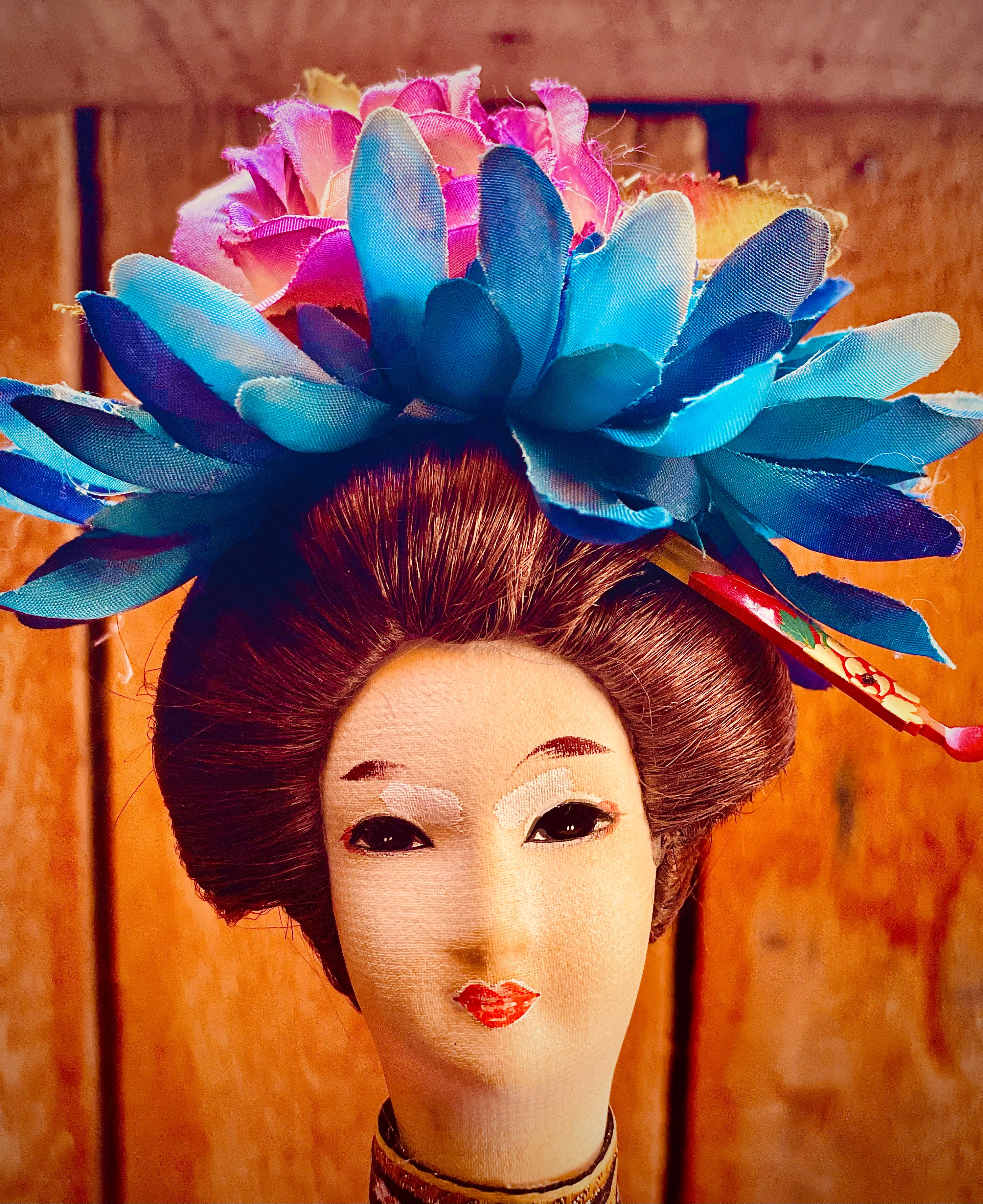 Close up of Geisha doll head that sits on top of a dinosaur body niightlite